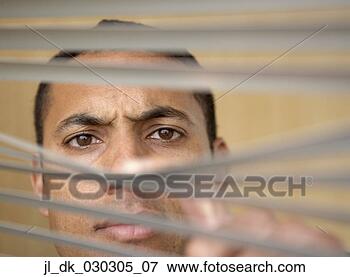 Picture - portrait of a 
businessman looking 
through the blinds 
of a window. fotosearch 
- search stock 
photos, pictures, 
images, and photo 
clipart