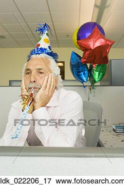 Picture - senior businessman 
looking sad in 
a cubicle with 
a party hat. fotosearch 
- search stock 
photos, pictures, 
images, and photo 
clipart
