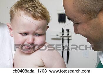 Stock Photo - male doctor smiling 
looking at a baby 
boy. fotosearch 
- search stock 
photos, pictures, 
images, and photo 
clipart