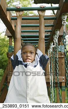 Stock Photography - young boy hanging 
from play structure. 
fotosearch - search 
stock photos, 
pictures, images, 
and photo clipart
