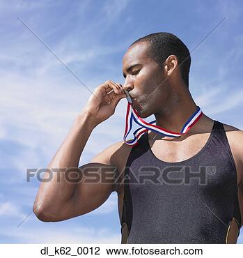 Stock Photo - african male athlete 
kissing medal, 
perth, australia. 
fotosearch - search 
stock photos, 
pictures, images, 
and photo clipart
