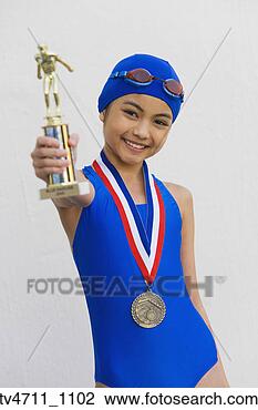 Stock Photo - hispanic girl 
in bathing suit 
with metal and 
trophy. fotosearch 
- search stock 
photos, pictures, 
images, and photo 
clipart