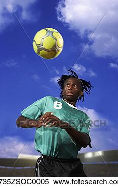 Stock Image - male soccer player 
headering the 
ball. fotosearch 
- search stock 
photos, pictures, 
images, and photo 
clipart
