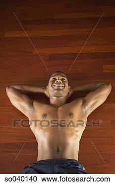 Stock Photography - mid adult man 
doing exercises 
on the floor. 
fotosearch - search 
stock photos, 
pictures, images, 
and photo clipart