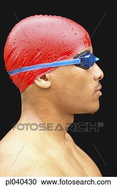 Stock Photography - side profile of 
a male swimmer 
wearing a swimming 
cap and swimming. 
fotosearch - search 
stock photos, 
pictures, images, 
and photo clipart
