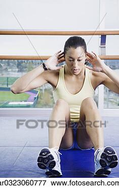 Picture - woman doing sit 
ups indoors. fotosearch 
- search stock 
photos, pictures, 
images, and photo 
clipart