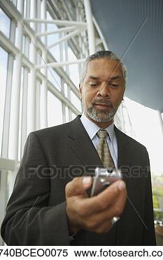 Stock Image - african businessman 
with cell phone, 
 north bethesda, 
 maryland. fotosearch 
- search stock 
photos, pictures, 
images, and photo 
clipart