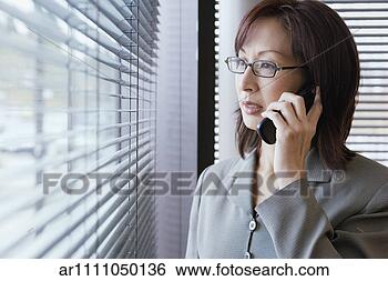 Stock Photo - businesswoman 
talking on her 
cell phone. fotosearch 
- search stock 
photos, pictures, 
images, and photo 
clipart