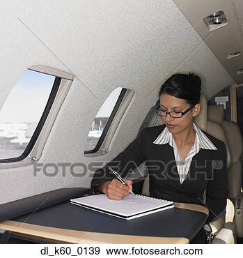 Stock Photograph - businesswoman 
working inside 
airplane, perth, 
australia. fotosearch 
- search stock 
photos, pictures, 
images, and photo 
clipart