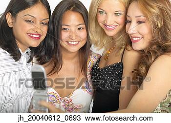 Stock Photo - group of young 
women standing 
together looking 
at a mobile phone. 
fotosearch - search 
stock photos, 
pictures, images, 
and photo clipart