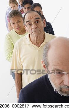 Picture - studio shot of 
people waiting 
on line. fotosearch 
- search stock 
photos, pictures, 
images, and photo 
clipart