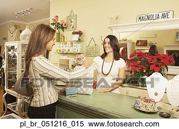 Stock Image - woman making a 
purchase at a 
boutique,  larkspur, 
 california. fotosearch 
- search stock 
photos, pictures, 
images, and photo 
clipart