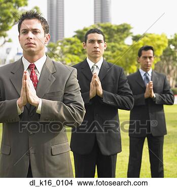 Stock Photo - three businessmen 
standing in a 
prayer position 
on a lawn. fotosearch 
- search stock 
photos, pictures, 
images, and photo 
clipart