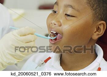 Stock Photo - dentist's hand 
holding dental 
mirror in boy's 
mouth. fotosearch 
- search stock 
photos, pictures, 
images, and photo 
clipart