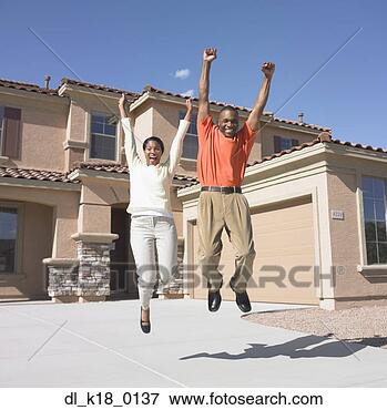 Picture - portrait of a 
mid adult couple 
jumping. fotosearch 
- search stock 
photos, pictures, 
images, and photo 
clipart
