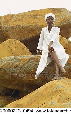 Stock Photo - african american 
woman sitting 
on rocks. fotosearch 
- search stock 
photos, pictures, 
images, and photo 
clipart