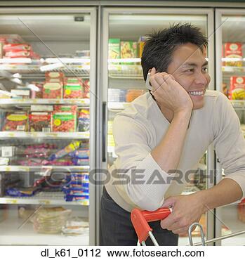 Stock Photo - asian man on cell 
phone at supermarket, 
perth, australia. 
fotosearch - search 
stock photos, 
pictures, images, 
and photo clipart
