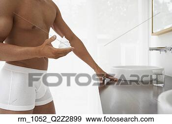 Stock Photograph - man wearing underwear 
with shaving cream 
in hand. fotosearch 
- search stock 
photos, pictures, 
images, and photo 
clipart
