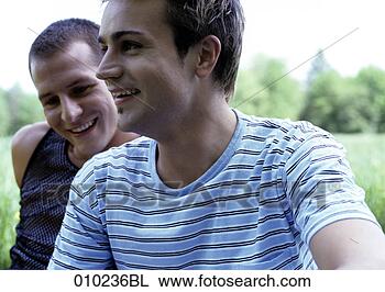 Stock Photo - close-up of young 
gay man (20-25 
years) his partner 
in the background. 
fotosearch - search 
stock photos, 
pictures, images, 
and photo clipart