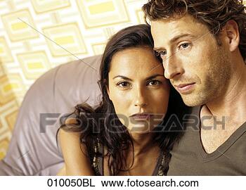 Stock Photo - couple on grey 
leather sofa looking 
serious. fotosearch 
- search stock 
photos, pictures, 
images, and photo 
clipart