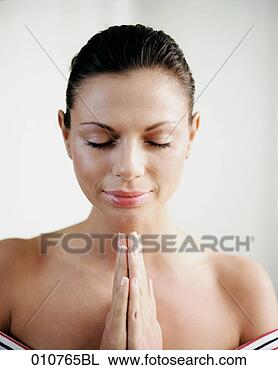 Stock Photo - young woman with 
closed eyes and 
folded hands. 
fotosearch - search 
stock photos, 
pictures, images, 
and photo clipart