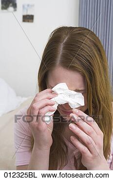 Stock Photo - crying young woman 
holding tissue. 
fotosearch - search 
stock photos, 
pictures, images, 
and photo clipart