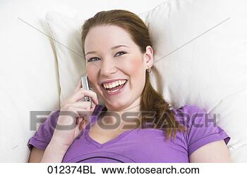 Stock Photo - laughing young 
woman talking 
on mobile phone. 
fotosearch - search 
stock photos, 
pictures, images, 
and photo clipart