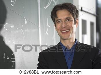 Stock Photo - portrait of smiling 
teacher standing 
at blackboard. 
fotosearch - search 
stock photos, 
pictures, images, 
and photo clipart