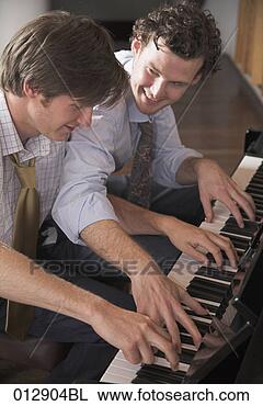 Stock Photo - two good friends 
playing four handed 
piano. fotosearch 
- search stock 
photos, pictures, 
images, and photo 
clipart
