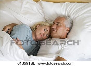 Stock Photo - mature couple 
sleeping in tender 
embrace. fotosearch 
- search stock 
photos, pictures, 
images, and photo 
clipart