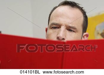 Stock Photo - close-up of young 
man reading red 
book. fotosearch 
- search stock 
photos, pictures, 
images, and photo 
clipart
