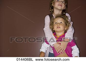 Stock Photo - girl holding her 
astonished looking 
little sister. 
fotosearch - search 
stock photos, 
pictures, images, 
and photo clipart
