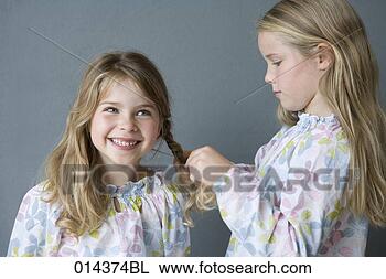 Stock Photo - girl plaiting 
hair of younger 
sistes. fotosearch 
- search stock 
photos, pictures, 
images, and photo 
clipart