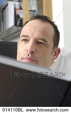 Stock Photo - headshot of young 
man reading book. 
fotosearch - search 
stock photos, 
pictures, images, 
and photo clipart