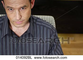 Stock Photo - portrait of doubtful 
looking young 
businessman. fotosearch 
- search stock 
photos, pictures, 
images, and photo 
clipart