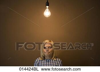 Stock Photo - portrait of teenager 
under lightbulb 
thinking heavily. 
fotosearch - search 
stock photos, 
pictures, images, 
and photo clipart