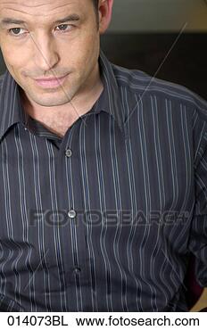 Stock Photo - portrait of young 
man sitting in 
striped shirt. 
fotosearch - search 
stock photos, 
pictures, images, 
and photo clipart
