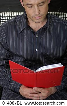 Stock Photo - portrait of young 
man reading red 
book. fotosearch 
- search stock 
photos, pictures, 
images, and photo 
clipart