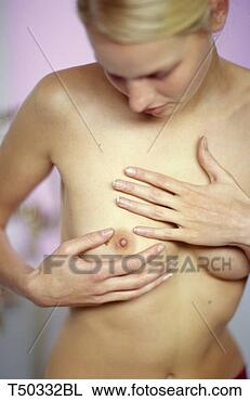 Stock Photo - woman examining 
her breast. fotosearch 
- search stock 
photos, pictures, 
images, and photo 
clipart