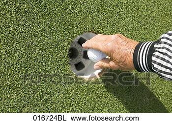 Stock Photo - close-up of mature 
adult taking golf 
ball from hole. 
fotosearch - search 
stock photos, 
pictures, images, 
and photo clipart