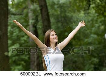 Stock Photo - portrait of happy 
young woman in 
park. fotosearch 
- search stock 
photos, pictures, 
images, and photo 
clipart