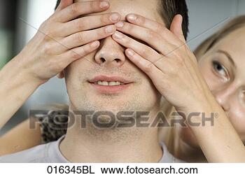 Stock Photo - young woman playing 
peekaboo with 
boyfriend. fotosearch 
- search stock 
photos, pictures, 
images, and photo 
clipart