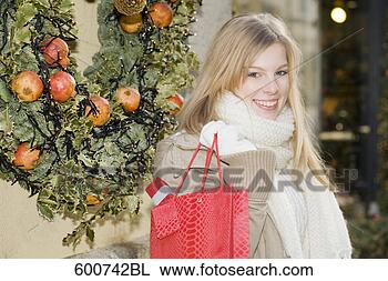 Stock Photo - portrait of young 
woman carrying 
shopping bag. 
fotosearch - search 
stock photos, 
pictures, images, 
and photo clipart