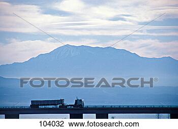 Stock Photo - semi-truck crossing 
bridge by mountains. 
fotosearch - search 
stock photos, 
pictures, images, 
and photo clipart