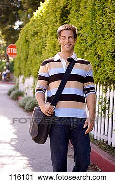 Stock Photography - young man walking 
on sidewalk. fotosearch 
- search stock 
photos, pictures, 
images, and photo 
clipart