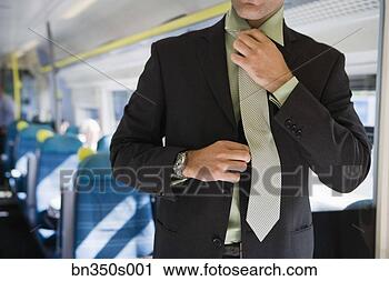 Stock Photography - man adjusting 
tie. fotosearch 
- search stock 
photos, pictures, 
images, and photo 
clipart