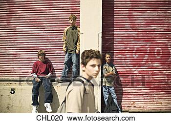 Stock Photography - idle male teenagers  hanging out together.  fotosearch - search  stock photos,  pictures, wall  murals, images,  and photo clipart