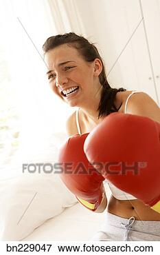 Picture - woman wearing 
boxing gloves. 
fotosearch - search 
stock photos, 
pictures, images, 
and photo clipart