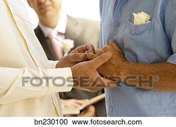 Stock Photography - close up of a 
male couple's 
hands during a 
wedding ceremony. 
fotosearch - search 
stock photos, 
pictures, images, 
and photo clipart