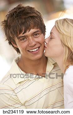 Stock Photograph - girlfriend giving 
boyfriend kiss 
on the cheek. 
fotosearch - search 
stock photos, 
pictures, images, 
and photo clipart